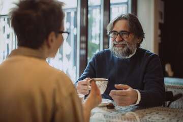 Mature man enjoying coffee and conversation on a date