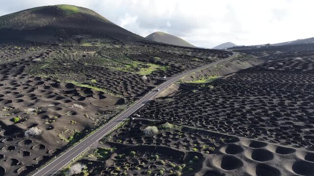 Road winding through La Geria volcanic vineyards Lanzarote