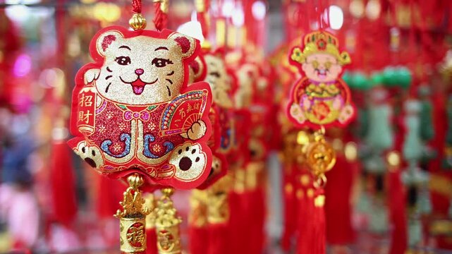 Colorful red and golden decorative elements sold on an vietnamese street market prior to the Tet holiday or Lunar new year in Vietnam, Asia. Selective focus close up video.