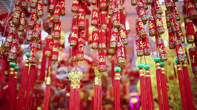 Colorful red and golden decorative elements sold on an vietnamese street market prior to the Tet holiday or Lunar new year in Vietnam, Asia. Selective focus close up video.