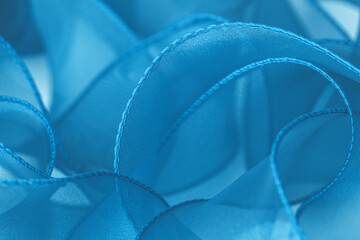 Curved blue organza ribbons background