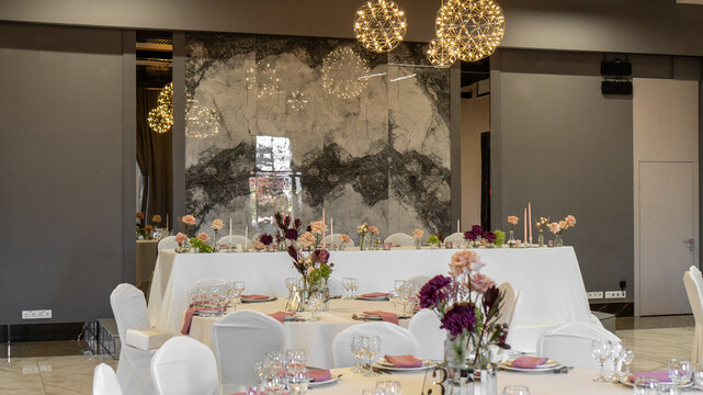 brides table. wedding flower arrangement in pink, purple and green tones. wedding decorations, pink server table. rose, leucadendron, purple chrysanthemum, candle, eustoma, pink astilbe, hydrangea
