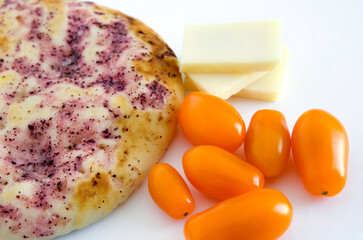 Closeup Details of Pita Bread, Cheddar Cheese and Orange Tomatoes