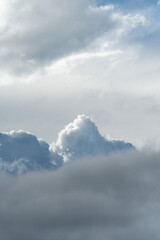 Cinematic minimalist blue sky with fluffy white cumulus clouds and vast copy space for background