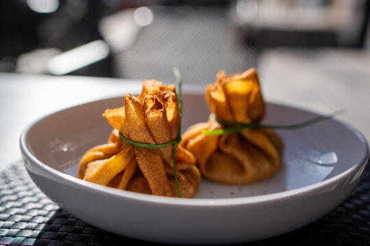 Detailed view of traditional blini pouches tied with chives for spring festival celebration