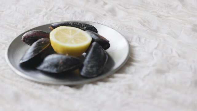 Close-Up of Turkish Stuffed Mussels Served with Lemon on Metal Plate
