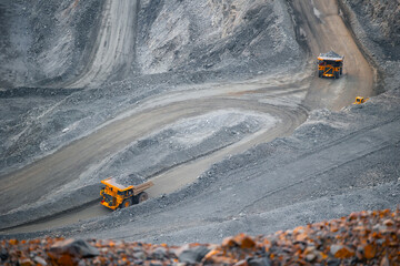 Open Pit Mining Scene with Dump Trucks on Winding Roads in Quarry gold, copper and iron ore. © Parilov