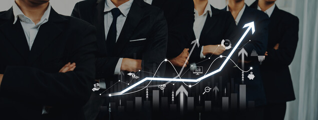 A group of confident professionals in business suits stands together with a dynamic growth graph overlay, symbolizing teamwork, strategy, and corporate success. Trope © InfiniteFlow