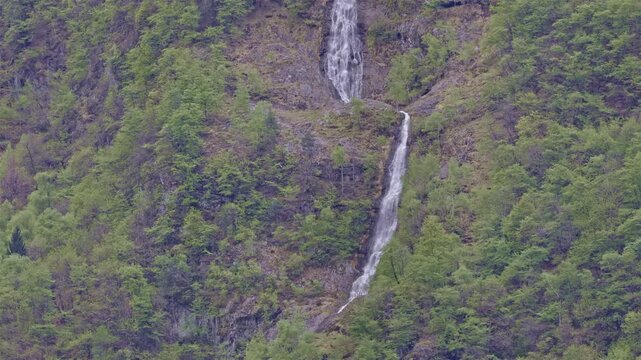 Waterfall high in the mountains, waterfall near Borgonuovo, Lombardy, Italy.