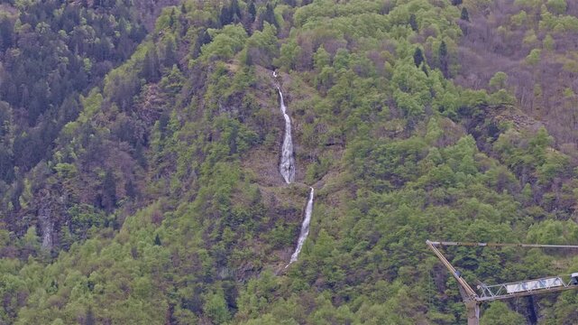 Waterfall high in the mountains, waterfall near Borgonuovo, Lombardy, Italy.
