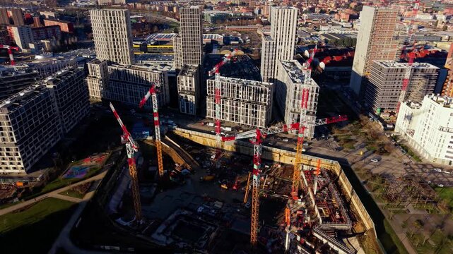 Aerial view of urban construction site with tower cranes