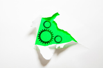 Green gear mechanism on white paper background with space for your text.