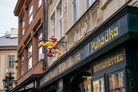 Prague, Czechia - Jan. 20, 2025: Jester sign above the entrance to the "At the Golden Lion" shop selling Czech toys and marionettes.