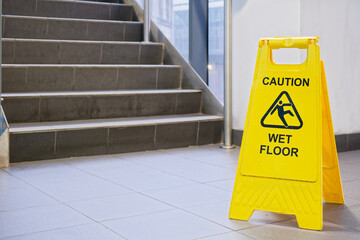 Caution wet floor cone safety notice at public stair