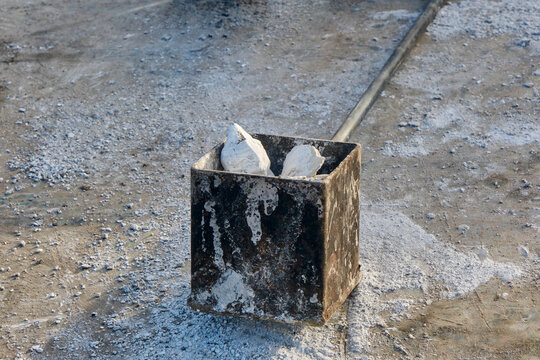 Chunks of carbide in a container. Carbide shooting or carbidschieten in dutch is a tradition in the Netherlands and usually takes place on New Year's Eve. The goal is to make a loud bang after the car