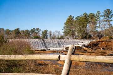 Sweetwater, Tennessee - February 10, 2026: A wide-angle view of High Falls, where water cascades over a historic dam structure © Deron