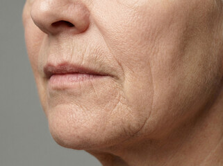 Fototapeta premium Mature facial skin with natural folds and wrinkles on elderly woman 