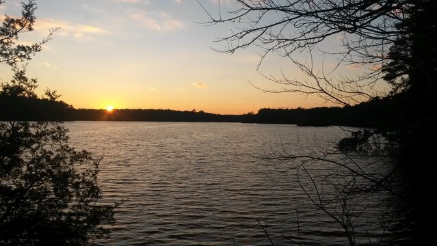 A beautiful colorful sunset over Lake Fred at Stockton University.