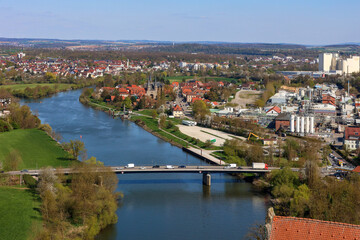 Fototapeta premium Panoramic View of a European River Town with Bridge and Industrial Landscape