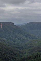 Fototapeta premium Beautiful flowing River in Fitzroy water Falls in Bowral NSW Australia beautiful colourful cloudy skies lovely waterfalls