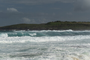 Powerful waves crash against rocky cliffs