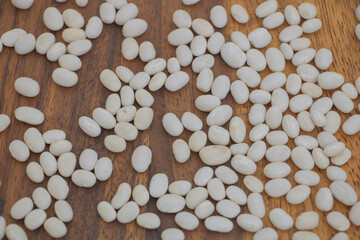 White Beans on Wooden Table - Dry Legumes Background