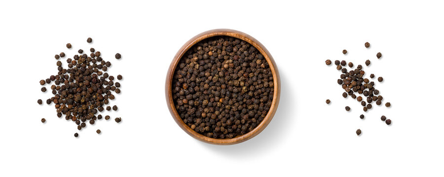 Top view of three piles of black peppercorns, scattered and arranged in a wooden bowl, isolated on a transparent background. Ideal for food design, packaging and culinary use.