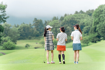 Fototapeta premium Female golfer walking on the fairway