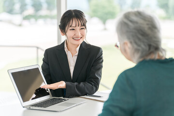 Businesswomen who explain, propose, guide and recommend to the elderly (bankers, asset management, stocks, investments, insurance)