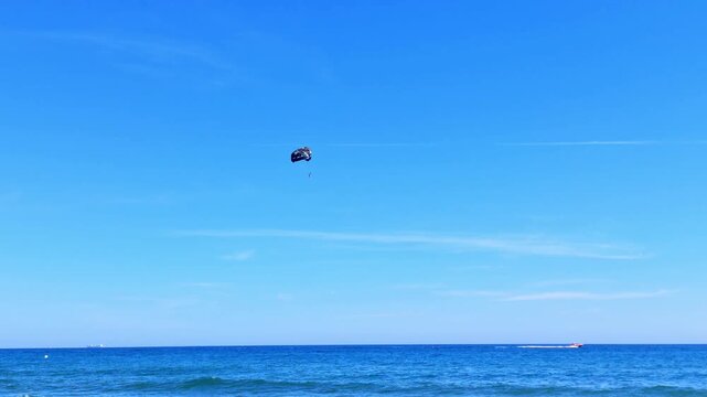 Paraglide flying in the blue sky
