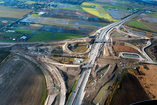 Canada, BC, Delta.  Aerial view of South Fraser Perimeter Road construction, crossing Hwy 99.
