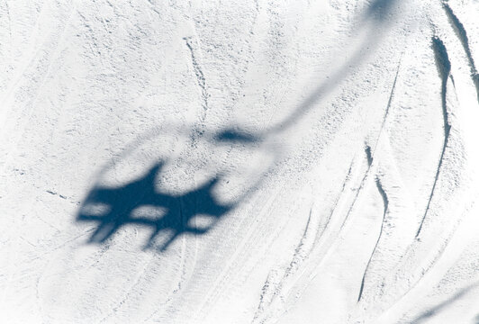 Canada, BC Sun Peaks.  Shadow of chairlift on ski run.  Sun Peaks Ski Resort.