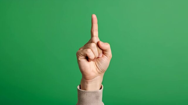 Upward pointing index finger hand gesture on vibrant green background
