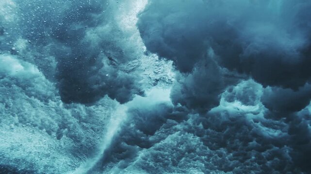 Powerful underwater wave collapse with foamy turbulence and cinematic tropical ocean light