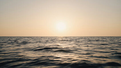 Fototapeta premium Sunset ocean horizon warm sunlight reflecting on gentle waves