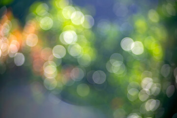 Obraz premium Soft Green Bokeh Light Background with Dreamy Natural Glow Abstract Nature Blur with Sparkling Sunlight Circles Fresh Spring Bokeh in Pastel Green and Blue Tones