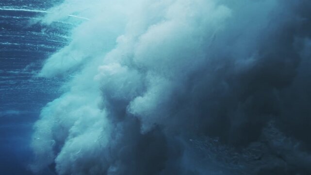 Dense underwater wave turbulence forming cloudlike foam and deep blue ocean texture