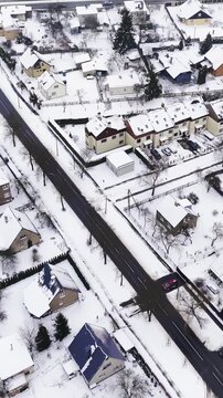 POV over-the-shoulder pushing a blue snow shovel along a cobblestone path, cutting a straight trench through fresh snow and stacking a neat berm beside a house.