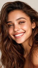 Obraz premium Young woman smiles happily showing white teeth for dental advertisement on light background