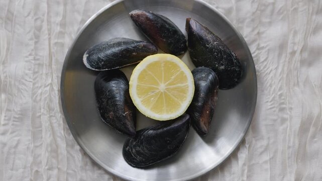 Close-Up of Turkish Stuffed Mussels Served with Lemon on Metal Plate
