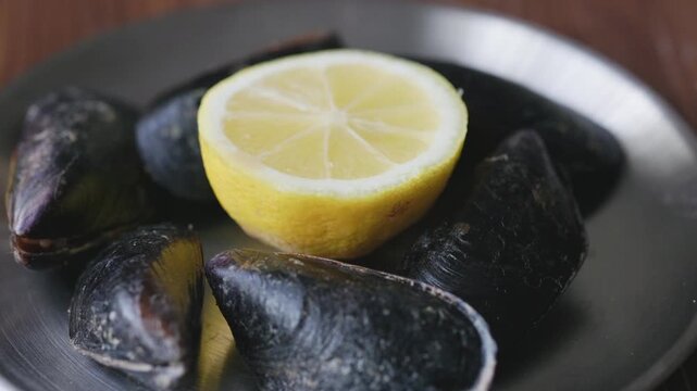 Close-Up of Turkish Stuffed Mussels Served with Lemon on Metal Plate
