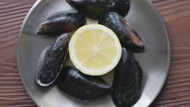 Close-Up of Turkish Stuffed Mussels Served with Lemon on Metal Plate
