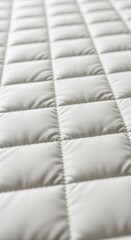Fototapeta premium Close-up of a Quilted White Fabric Surface with Soft Padding.