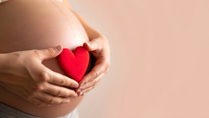 Expectant Mother Cradling Heart Symbol on Baby Bump with Love