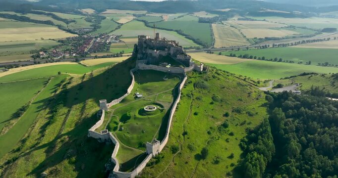 4K push In camera movement aerial drone view of the ruins of Spis Castle in eastern Slovakia, the castle is situated above the town of Spisske Podhradie, UNESCO Heritage listed site, Spis, Slovakia