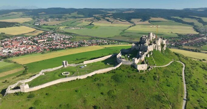 4K pull out camera movement aerial drone view of the ruins of Spis Castle in eastern Slovakia, the castle is situated above the town of Spisske Podhradie, UNESCO Heritage listed site, Spis, Slovakia