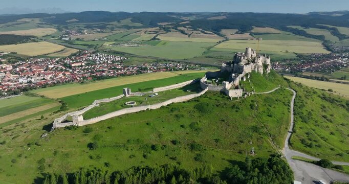 4K Push in camera movement aerial drone view of the ruins of Spis Castle in eastern Slovakia, the castle is situated above the town of Spisske Podhradie, UNESCO Heritage listed site, Spis, Slovakia