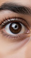 Naklejka premium Extreme close up captures human eye displaying a circular processing indicator reflected on the dark iris