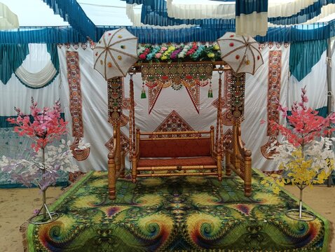 Traditional Indian Wedding Swing Jhula Decor with Floral Canopy and Festive Backdrop
