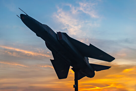 Sun rises behind silhouette image of Indian Air Force's fighter jet plane MIG-29 displayed at NDA chowk in Pune